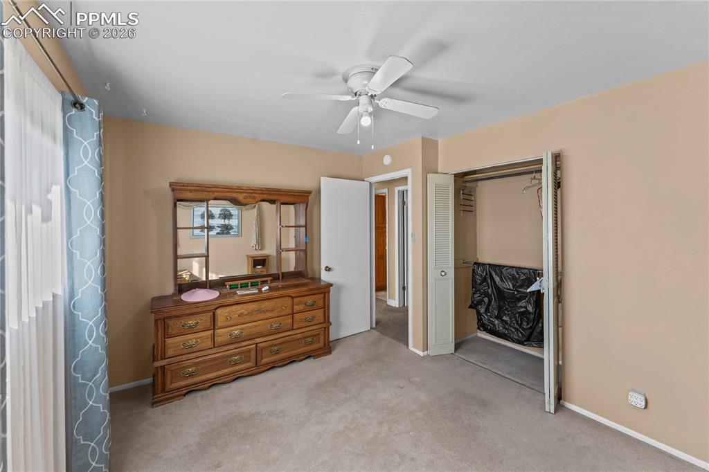 Image 26 of 41: Bedroom featuring a ceiling fan, light carpet, and a closet
