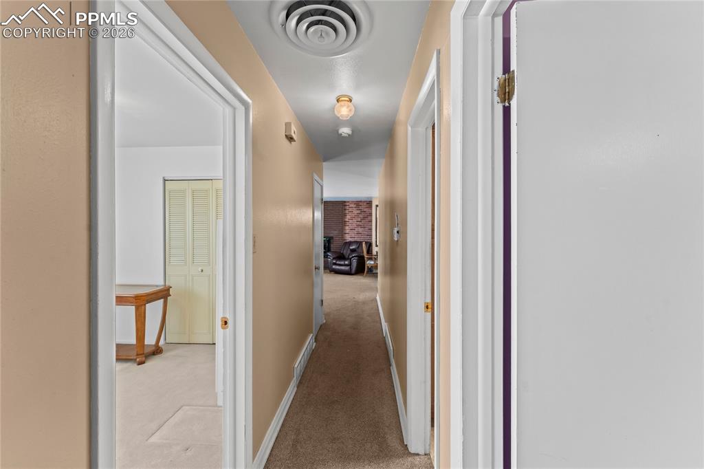 Image 27 of 41: Hall with light carpet and baseboards