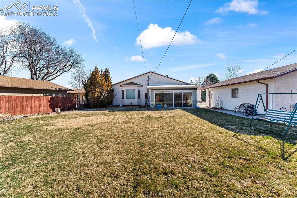 Image 38 of 41: Back of house with a sunroom