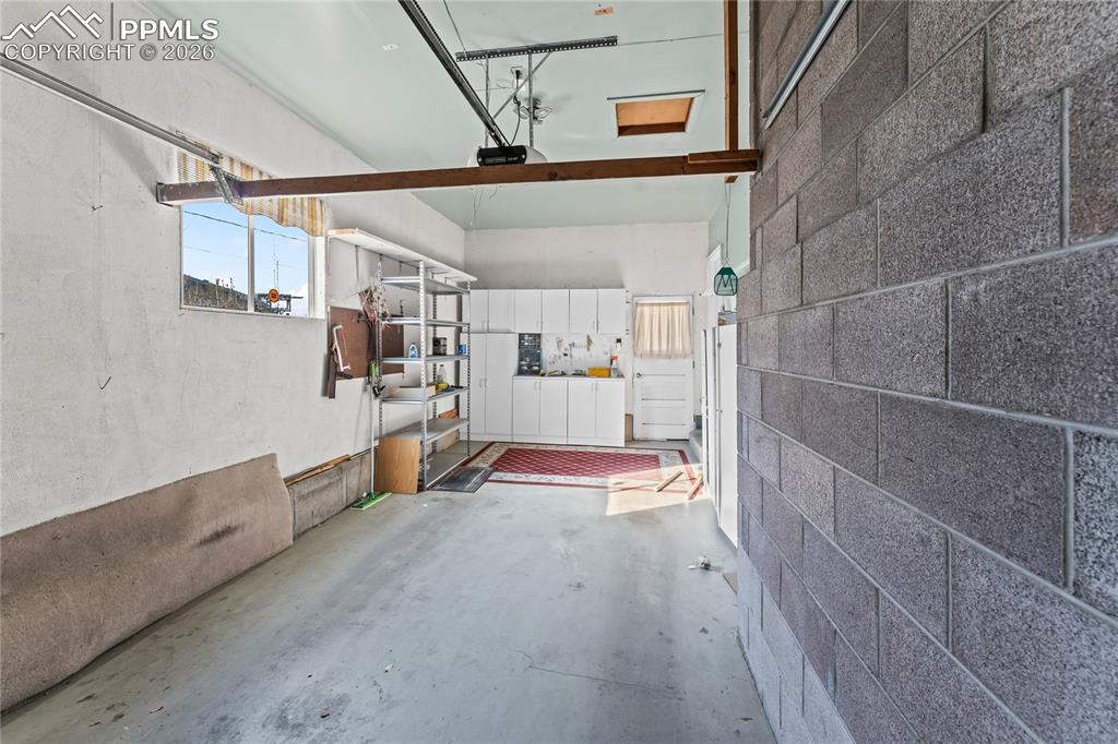 Image 41 of 41: Garage with concrete block wall