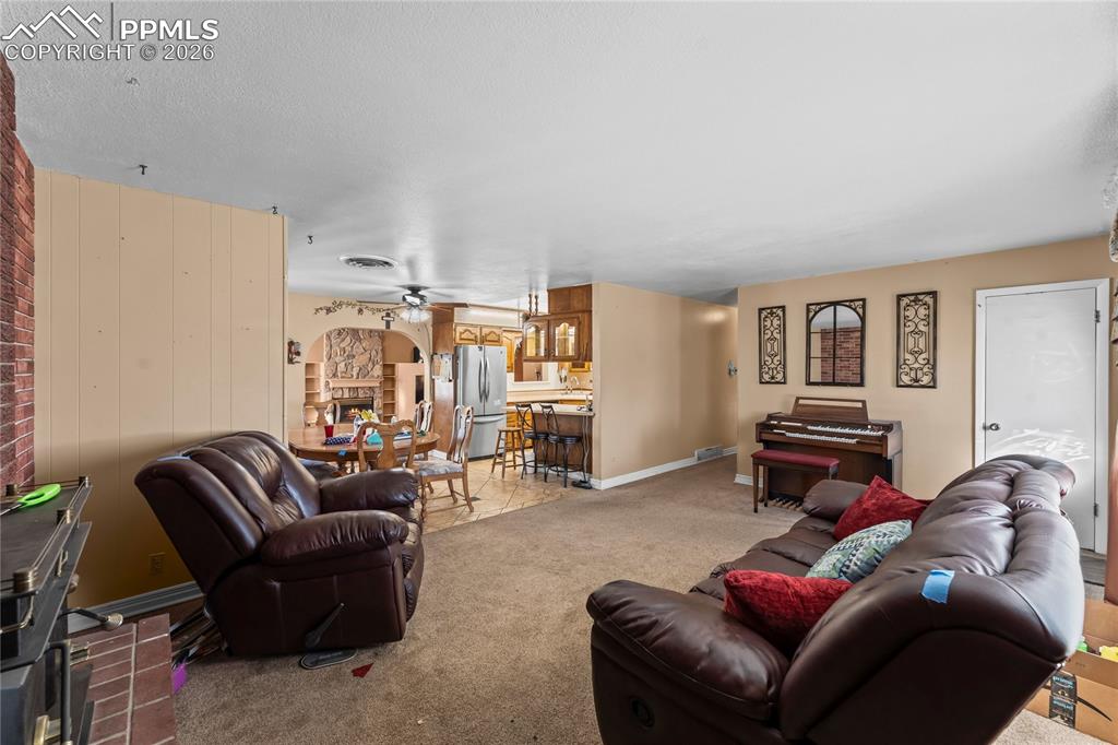 Image 6 of 41: Living area featuring ceiling fan and light colored carpet
