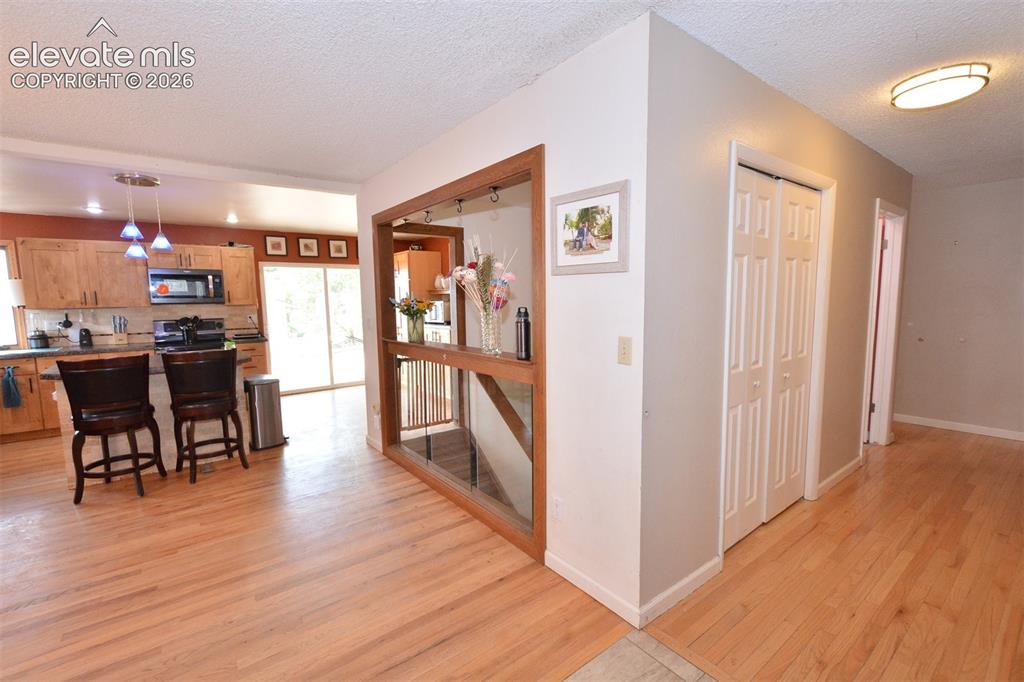Image 11 of 24: Hallway on main level to bedrooms