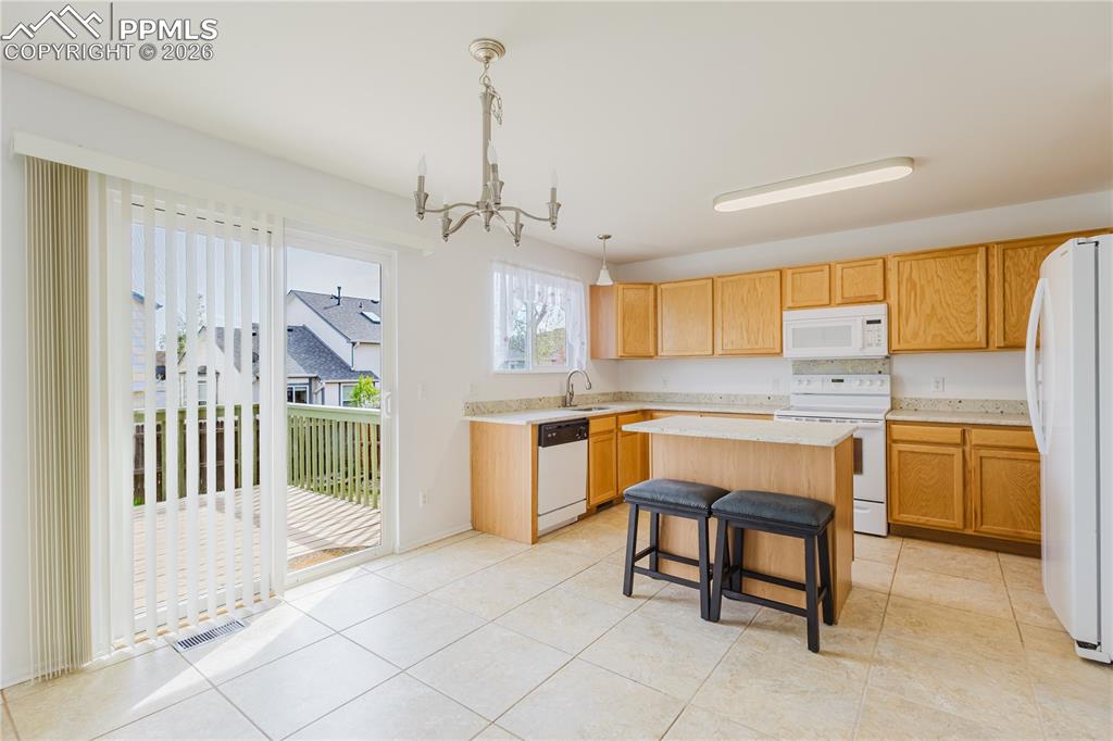 Image 13 of 42: The entry features a front door, hardwood flooring, and a large window with