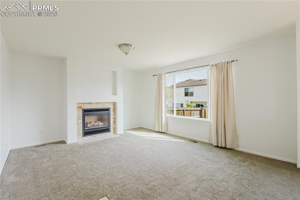 Image 14 of 42: The property features a staircase with carpeted treads and white risers, le