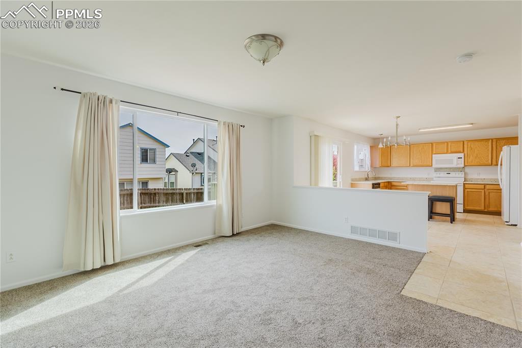 Image 15 of 42: Kitchen featuring a white side-by-side refrigerator, wood cabinetry, and a 