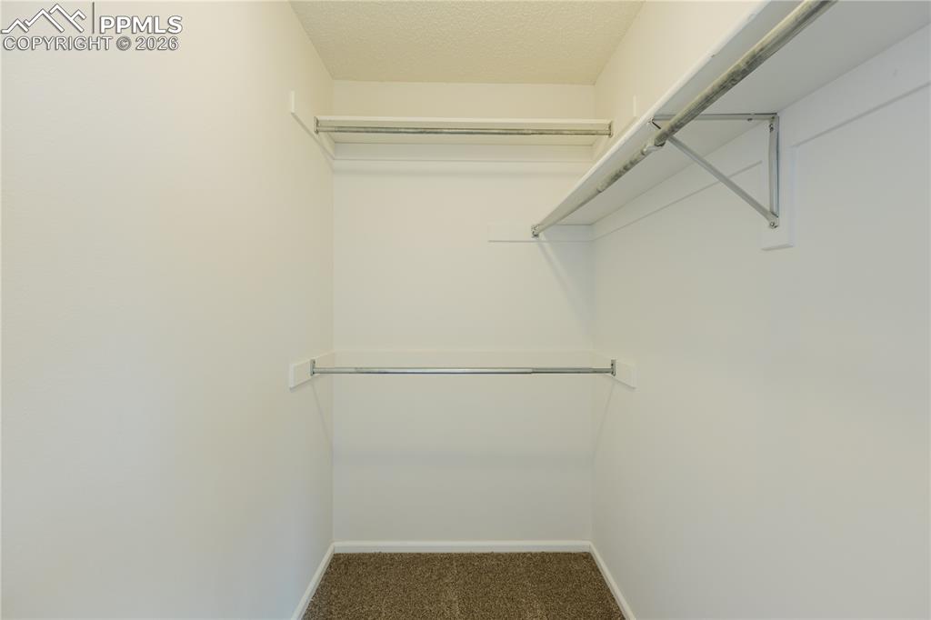 Image 18 of 42: Family room area featuring a fireplace with stone surround, a large window,