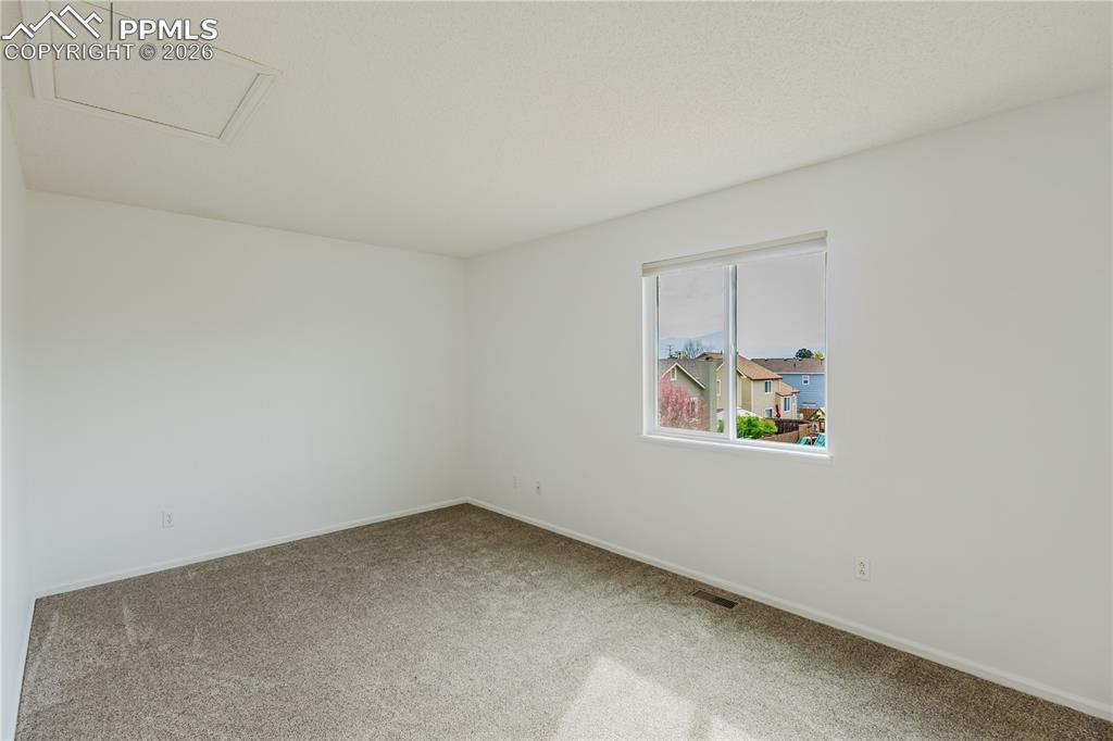 Image 21 of 42: The 1/2 bathroom features a vanity with a white sink, a mirror with overhea