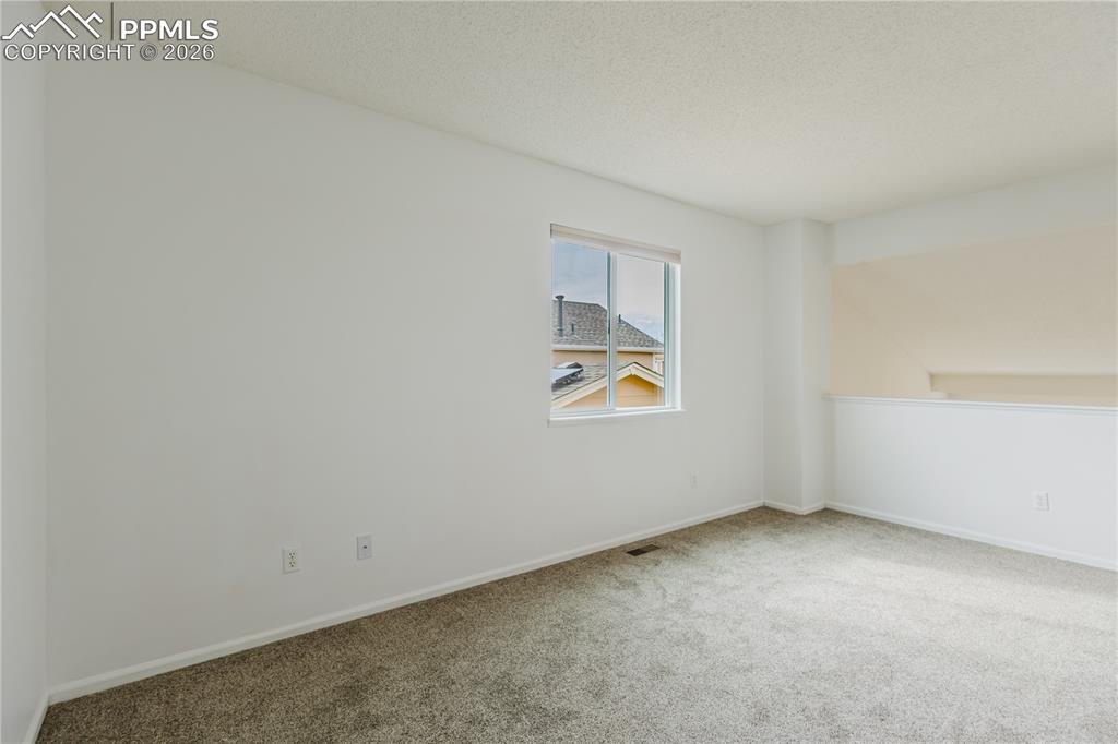 Image 22 of 42: This closet features white walls, carpeted flooring, and two levels of hang