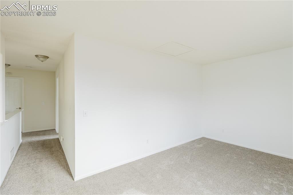 Image 24 of 42: The freshly painted walls and features a room with colored carpet flooring 