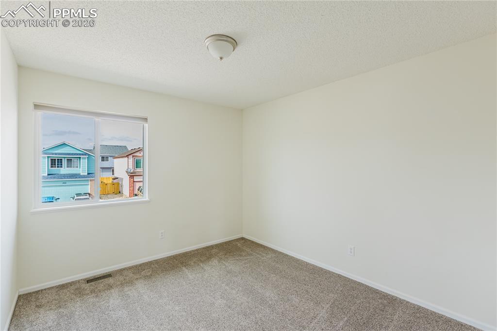 Image 27 of 42: Bright room featuring  carpet and white walls extra room or Office space, o