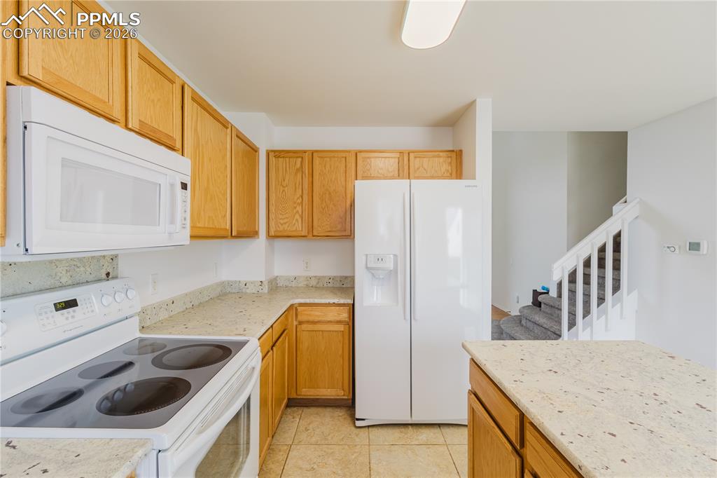 Image 3 of 42: The entry features a front door, hardwood entry, newly carpeted flooring