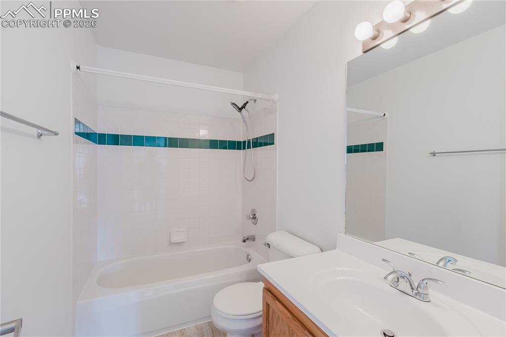 Image 31 of 42: This bedroom features a window providing natural light, neutral-toned carpe