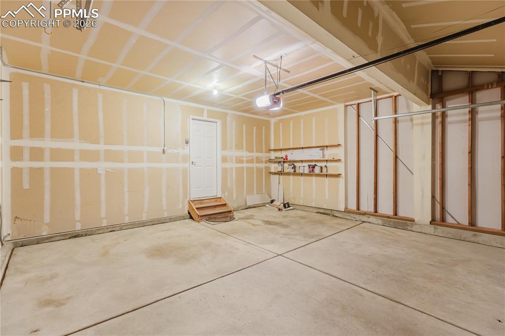 Image 41 of 42: This property features a gray shingle roof and a spacious backyard with a f