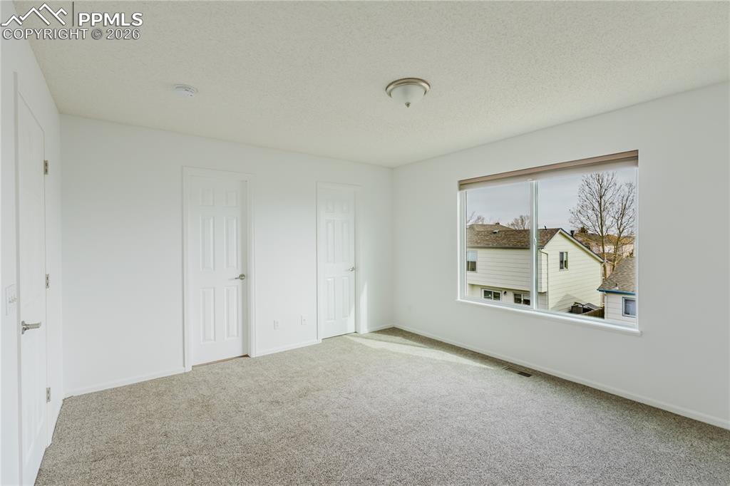 Image 7 of 42: Kitchen featuring a white appliances, wood cabinetry, and a kitchen island 