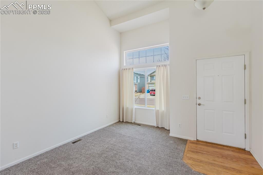 Image 9 of 42: Family room area featuring a fireplace with stone surround, a large window,