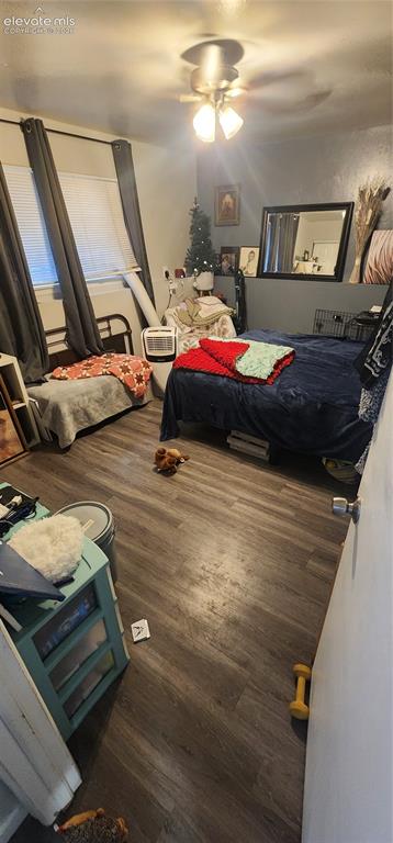 Image 10 of 18: Apt 2 - Wood-finish flooring with a ceiling fan light fixture