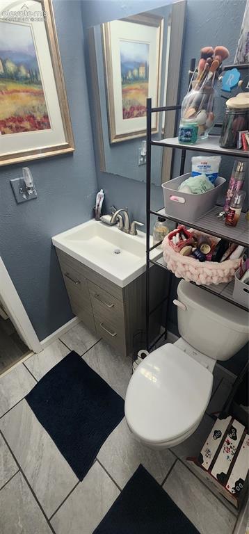 Image 17 of 18: Apt 2 - Vanity with integrated sink, chrome faucet, and storage cabinetry
