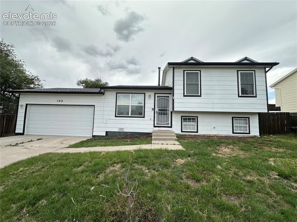 Caption: White exterior siding with black trim windows