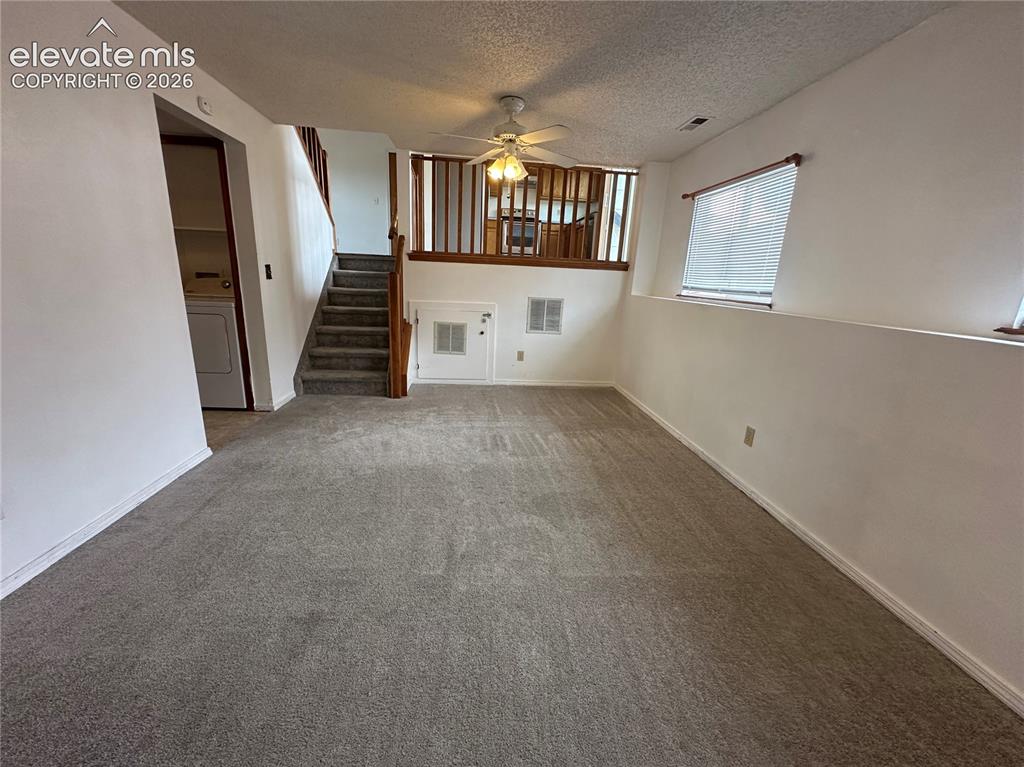 Image 10 of 15: Versatile room featuring broadloom carpeting, crisp white walls, a ceiling