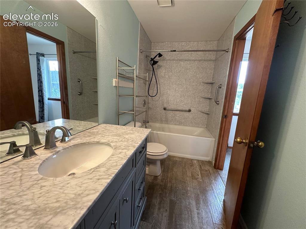 Image 12 of 15: Bathroom featuring a modern vanity with a marble-finish countertop, undermo