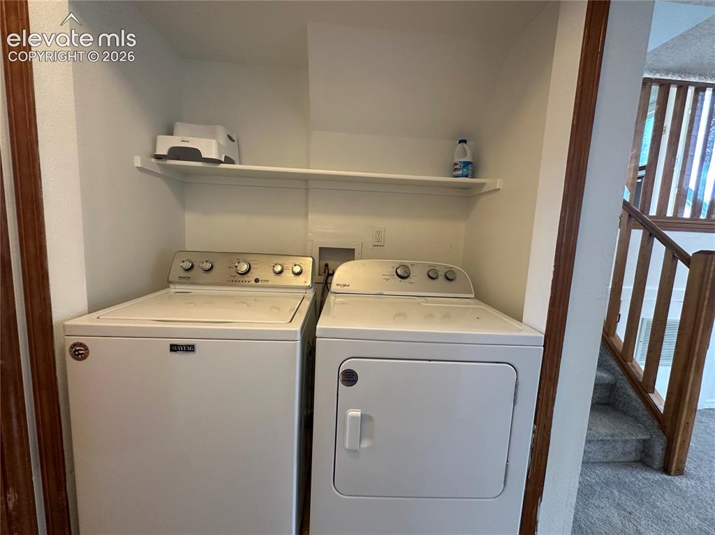 Image 9 of 15: Dedicated laundry area featuring a white top-load washing machine and white