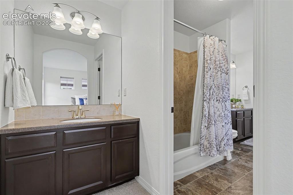 Image 21 of 36: Private vanity in bedroom with door to full bath