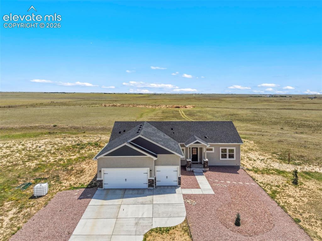 Image 34 of 38: Ranch-style residence featuring a two-car garage, concrete driveway, and a