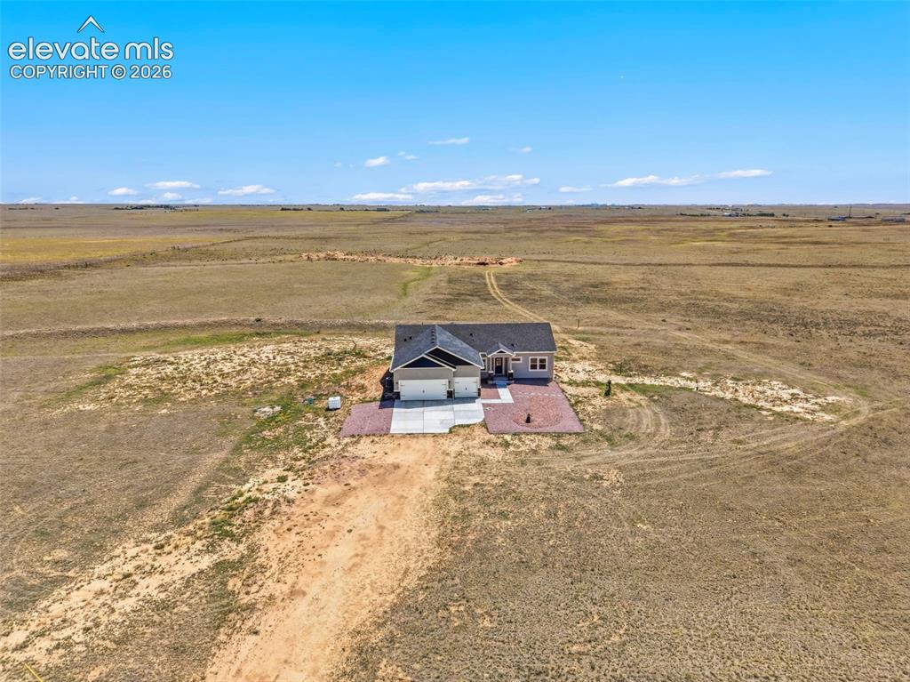 Image 37 of 38: Ranch-style residence featuring a prominent two-car garage, light-toned sid