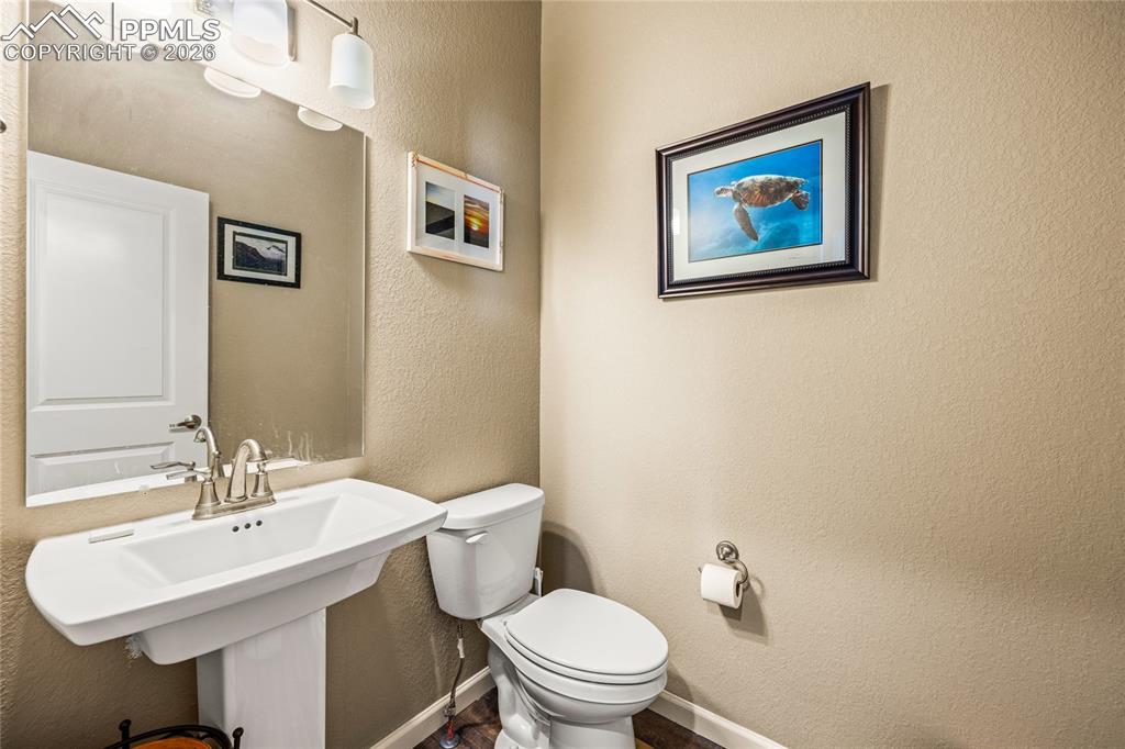 Image 11 of 25: Half-bath on main just inside garage entry door