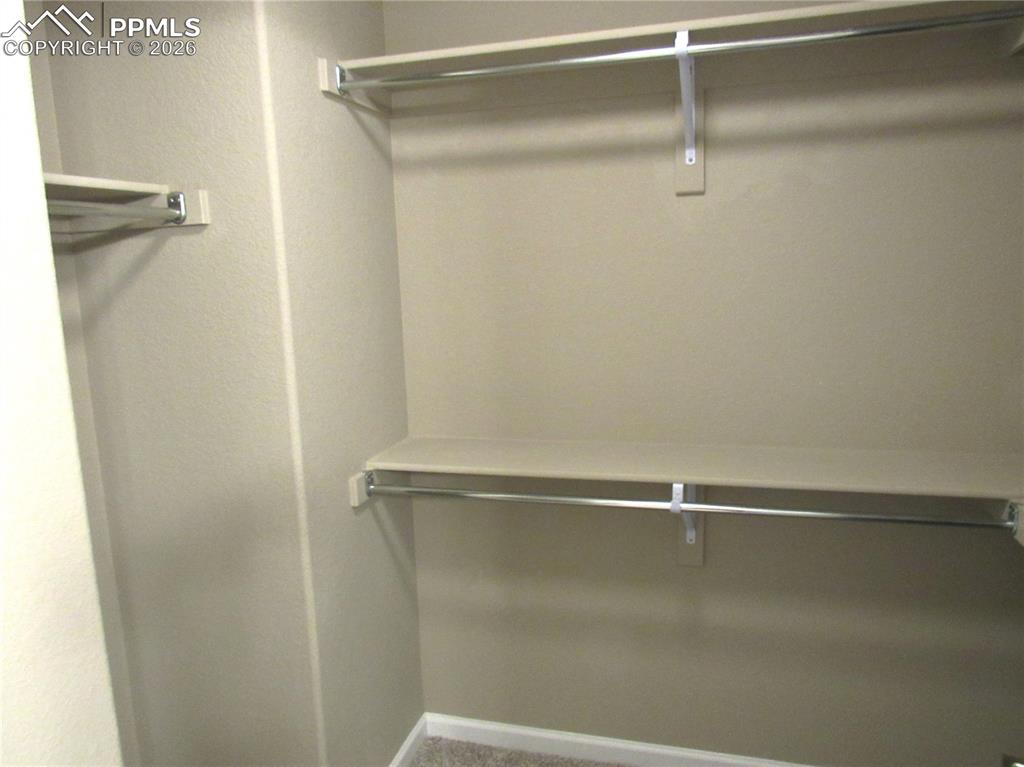 Image 15 of 25: Walk-in closet off of master bedroom