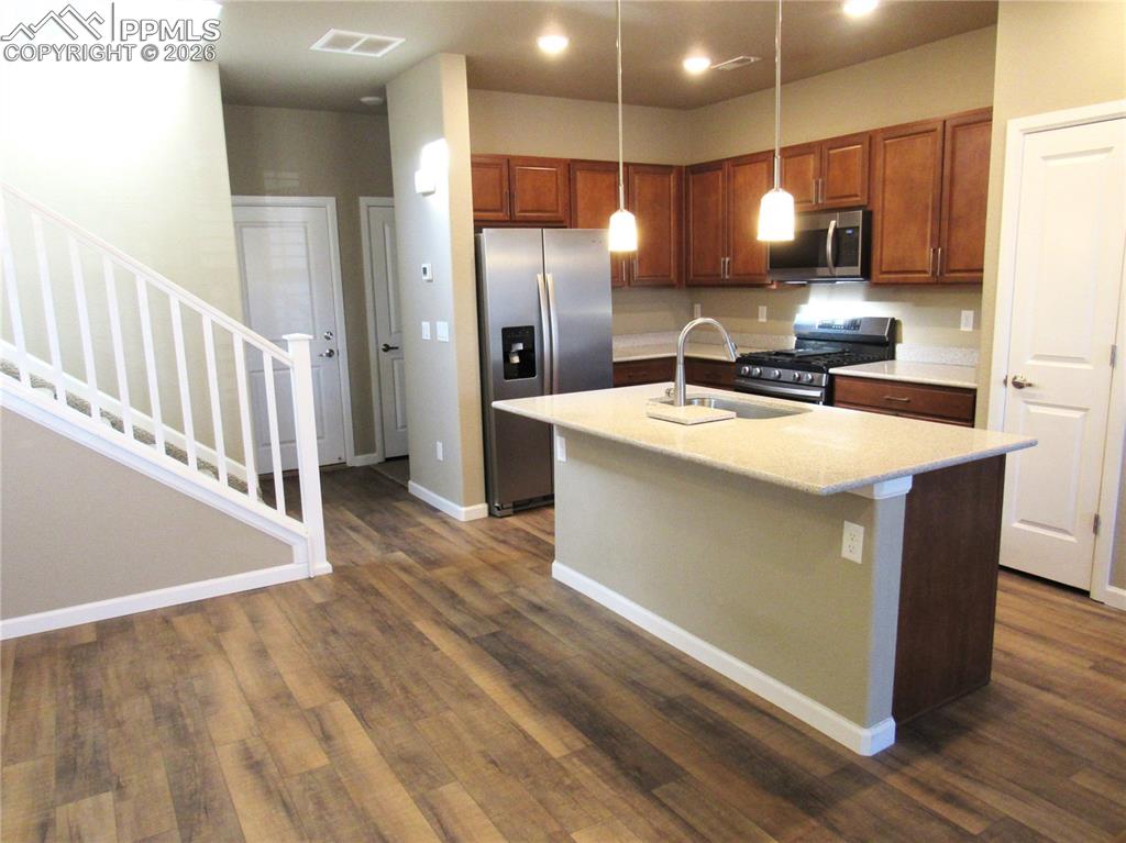 Image 4 of 25: Recessed and pendant lighting; stainless steel appliances; pantry