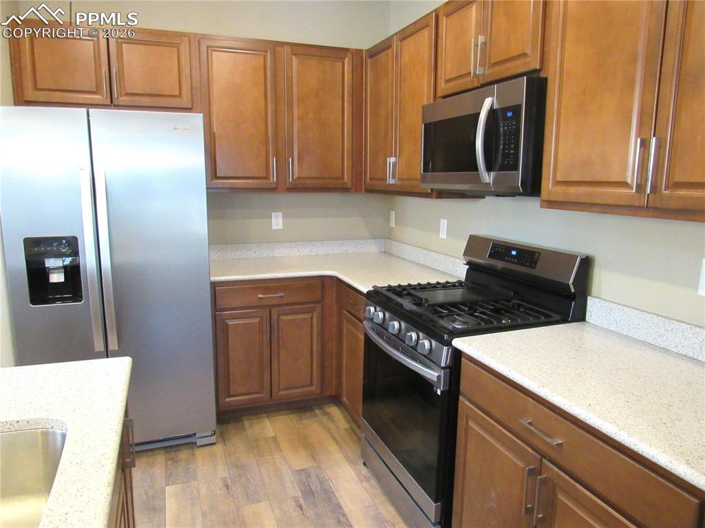 Image 7 of 25: Gas stove and stainless-steel appliances