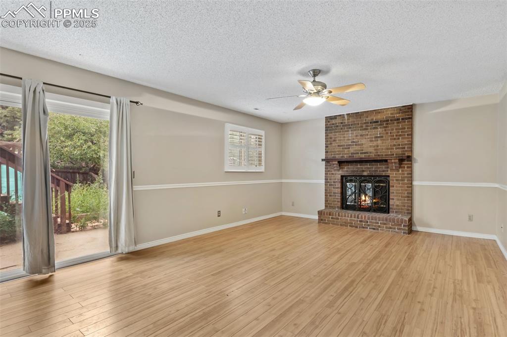 Image 22 of 34: Fireplace family room with walkout