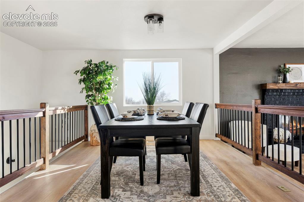 Image 19 of 50: Dining area featuring light wood-finish flooring, a contemporary semi-flush