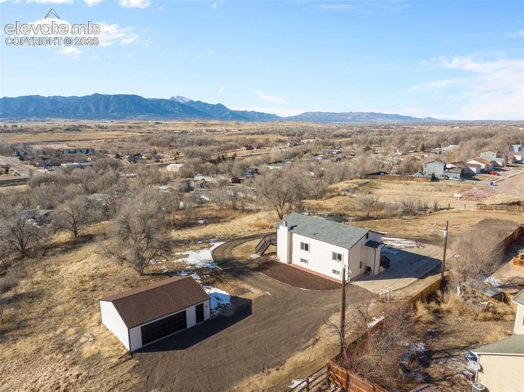 Image 49 of 50: Expansive property featuring a two-story residence with a light-colored ext