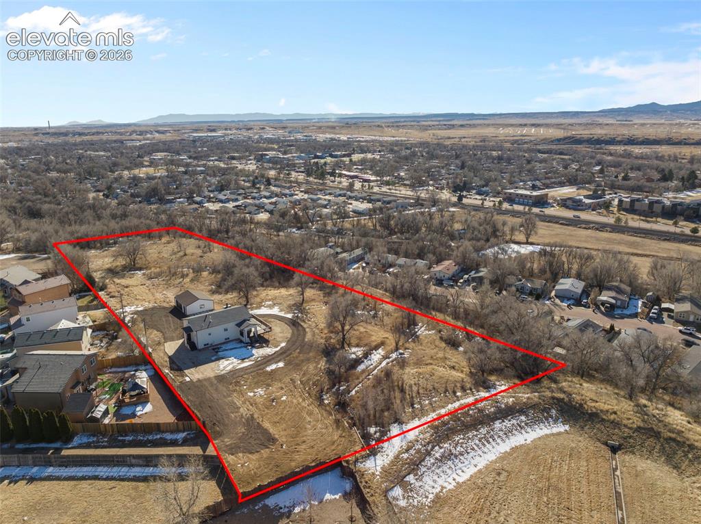 Image 50 of 50: Aerial depiction of a sprawling property featuring a white residence with a