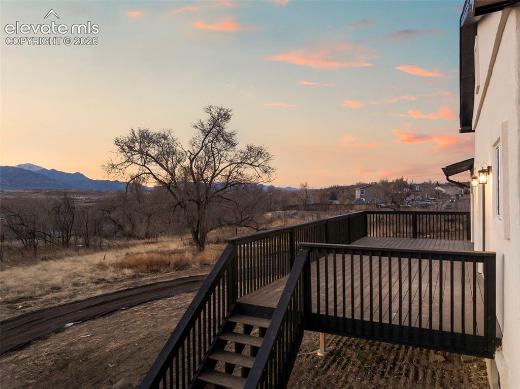 Image 8 of 50: Spacious outdoor deck with dark wood-finish decking and railings