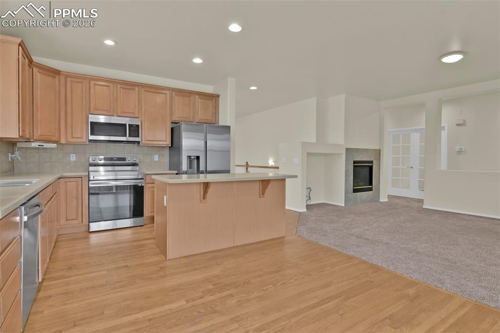 Image 10 of 49: Spacious kitchen with island, stainless steel appliances and eating nook