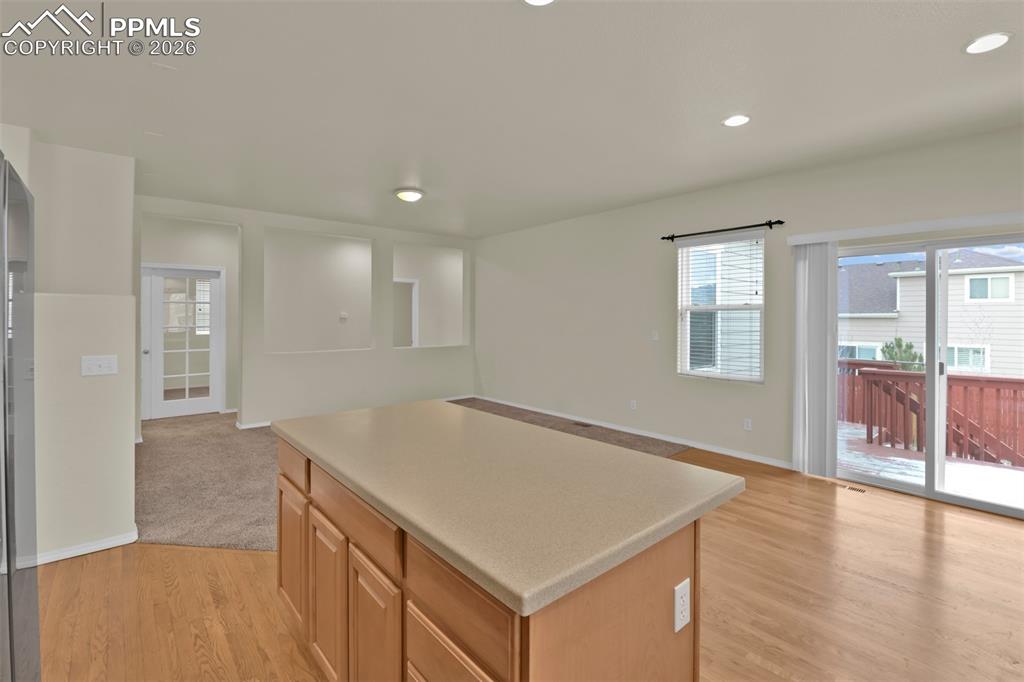 Image 13 of 49: Kitchen with eating nook and walk-out to the deck