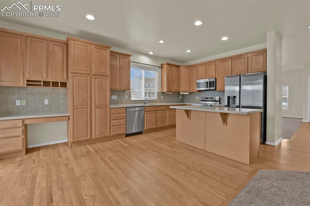 Image 9 of 49: Spacious kitchen with island, and stainless steel appliances