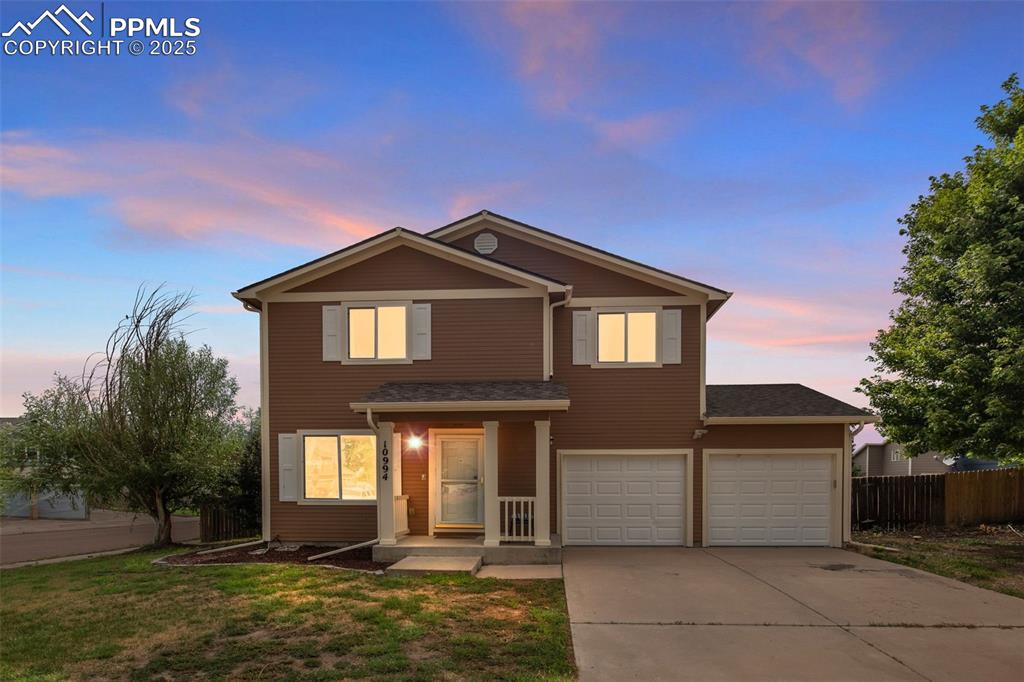 Caption: Traditional-style home with concrete driveway and an attached garage