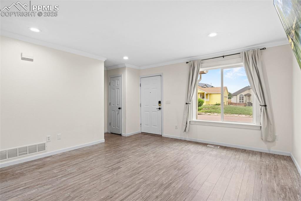 Image 11 of 39: Foyer featuring crown molding, light wood-style flooring, and recessed ligh