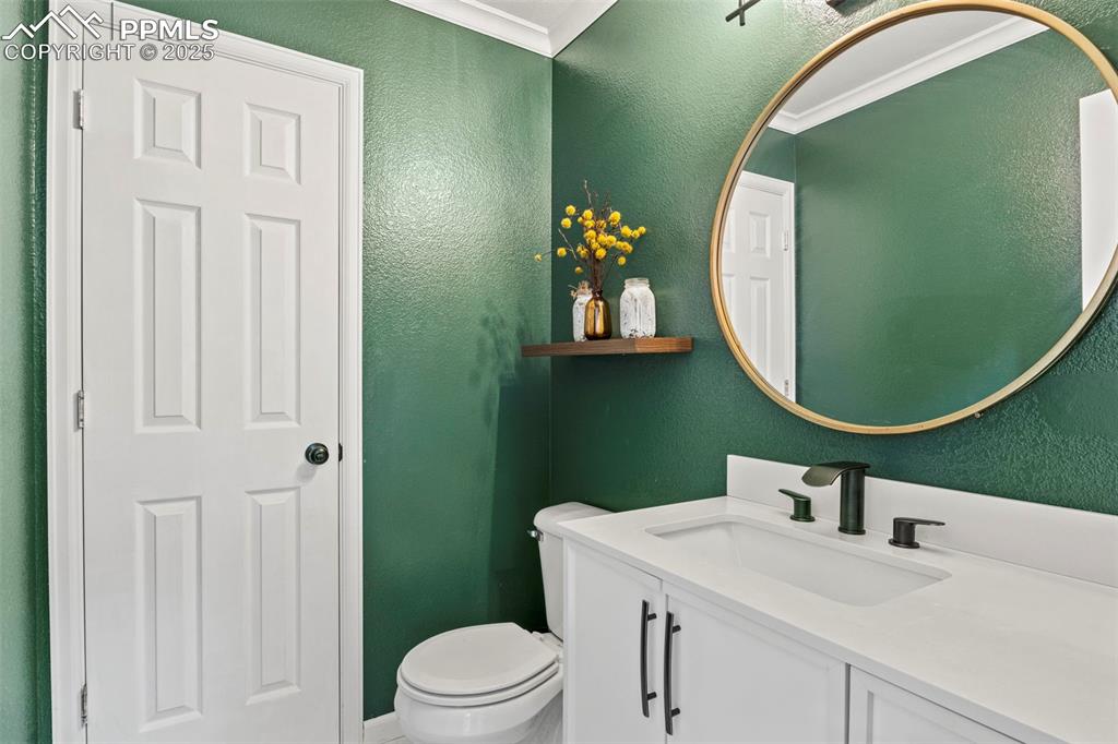 Image 19 of 39: Half bathroom featuring a textured wall and vanity