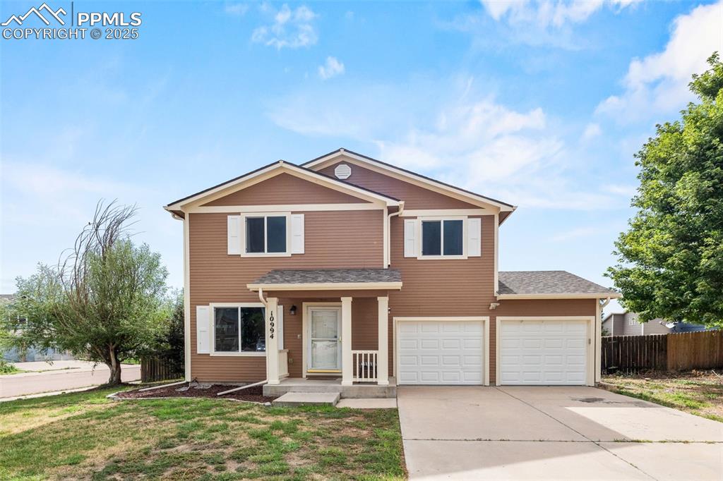 Image 2 of 39: Traditional-style house featuring concrete driveway, an attached garage, an