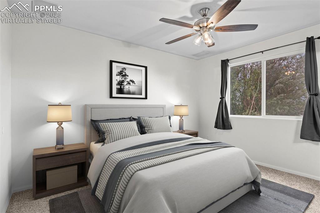 Image 20 of 39: Bedroom with carpet floors and a ceiling fan - virtually staged