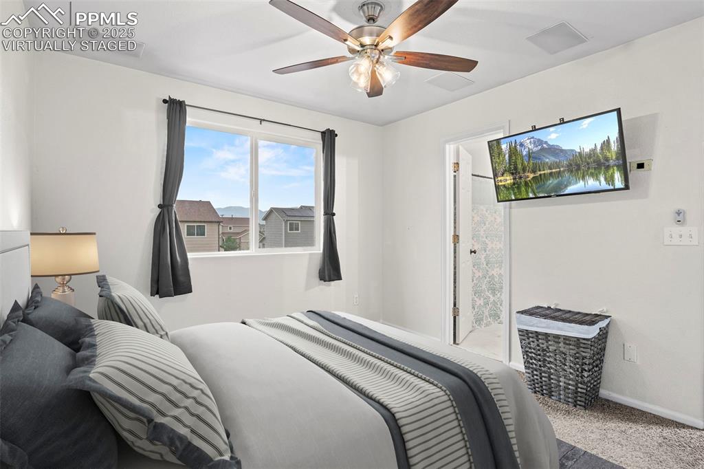 Image 22 of 39: Bedroom featuring carpet and a ceiling fan - virtually staged