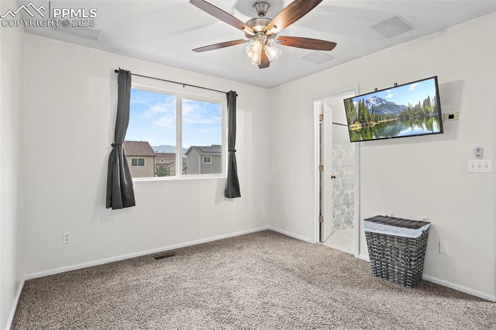 Image 23 of 39: Unfurnished room featuring carpet flooring and a ceiling fan