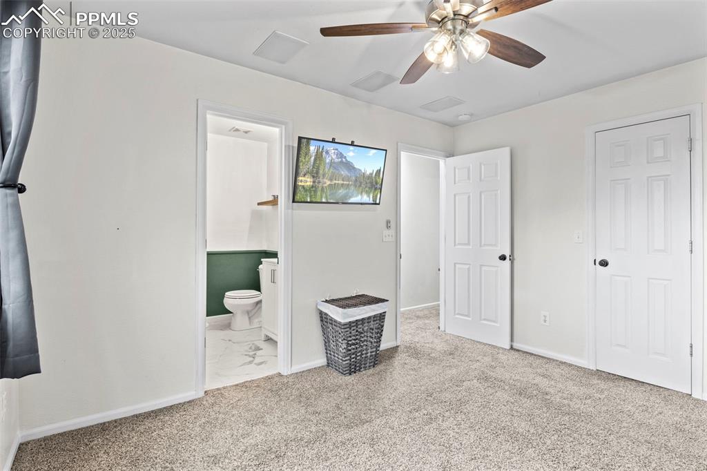 Image 25 of 39: Unfurnished bedroom featuring carpet flooring, ensuite bathroom, and ceilin