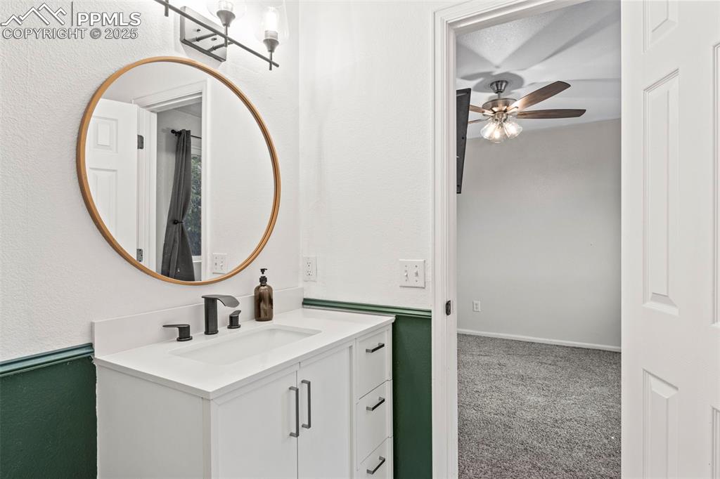 Image 28 of 39: Bathroom featuring ceiling fan and vanity