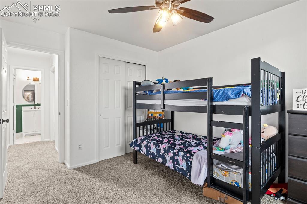 Image 31 of 39: Carpeted bedroom featuring a closet and a ceiling fan